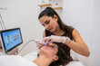 © PintoArt - Woman receiving facial skincare treatment at beauty salon