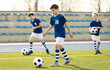 © matimix - Boys In Football Training With Balls. Children Playing Soccer – Youth Football Training and Match on an Outdoor Field. Kids Soccer Practice, Sports Education, and Team Development
