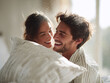 © SolaruS - Joyful couple having a pillow fight in bed bathed in warm light. Captures intimacy, love, and carefree moments. Great for romance, lifestyle, or relationship themes.