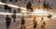 © kieferpix - Double exposure of people crossing a busy city street at night with motion lights, symbolizing urban energy, connection, and the pace of modern life.