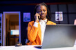 © DC Studio - Student at desk in phone call with teacher, requesting help to do homework, browsing internet on laptop. African american person doing telephone call and reading articles on laptop for school tasks