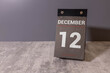 © Uladzislau - Wooden calendar December 12 on a white background close up.