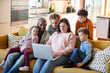 © Marko Geber - Adult parents and children happily watching laptop at home