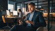 © Rahmat  - Successful Businessman Using Tablet in Modern Office Lounge Area at Night