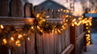 © Alex - Wooden fence decorated with glowing holiday lights and festive garlands, warm winter ambiance, soft evening glow.