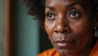 © Pete - Closeup portrait of a mature black woman looking thoughtful. Her deep eyes and visible wrinkles suggest wisdom and life experience. She gazes away with a contemplative, serious expression.