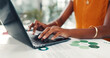 © FrameOn/peopleimages.com - Woman, hands and typing in office with laptop for sustainability report, esg policy info and review. Person, computer and paperwork for environmental compliance audit, strategy proposal and research.