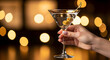 © tae - Hand holds a elegant martini glass beautiful bokeh lights capturing the essence of celebration and sophistication 97469833 1