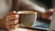 © khumthong - Woman's hand holding a coffee cup near a laptop keyboard work drink beverage