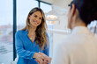 © we.bond.creations - Smiling woman shaking hands at dental clinic, symbolizing trust, satisfaction, and good service in modern healthcare