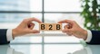 © deesignvalue - Business to business concept two hands holding blocks with B2B letters symbolizing partnership and collaboration in a corporate setting
