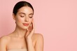 © Studenkova - Elegant woman with flawless skin, gently touching her cheek on soft pink background, exuding confidence and serenity. Banner with copy space for text to advertise face and body care products