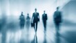 © morepiixel - A blurred depiction of business professionals walking, conveying a sense of motion and corporate atmosphere.