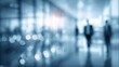© morepiixel - A blurred image depicting people walking through a modern corridor, illuminated by soft bokeh lighting, conveying a sense of motion and professional environment.