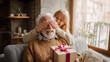 © Concept Island - Birthday, christmas or father day gift giving: elderly man receiving a surprise gift from a young woman, sitting together on a cozy sofa, the woman covering his eyes playfully, happy family moment