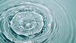 © Super Abi - Close-up of serene, clear water surface showing mesmerizing ripples, perfectly formed concentric circles showcasing elegant fluid motion from drop impact, creating calming abstract pattern