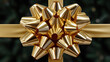© Moonroad - Golden gift bow ribbon shiny metallic curl foreground dreamy golden blur behind festive present decoration