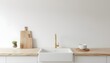 © Wool World - Minimalist kitchen sink and wooden countertop with cutting board and plant, clean white wall background