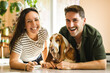 © Louis-Paul Photo - Couple and her Basset dog at home having great time