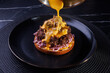 © Aleksei Zakharov - Poured Cheese Sauce Over Shredded Beef Sandwich On Toasted Bun