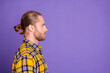 © deagreez - Portrait of a young handsome male model wearing a yellow plaid shirt against a purple background