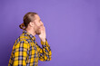 © deagreez - Young handsome guy in checkered yellow plaid shirt shouting with a smile in a purple background
