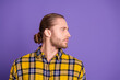 © deagreez - Young handsome male model wearing a yellow plaid shirt stands in profile against a purple background for fashion lifestyle and advertising content