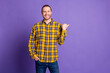 © deagreez - Handsome young man in yellow plaid shirt smiles against a purple background for casual fashion lifestyle advertising and promotion