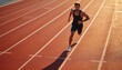 © miss irine - Strong male athlete runs on red track. Young man sprints fast, showing power and focus during intense workout. He trains hard outdoors at stadium in bright sunlight for speed training.
