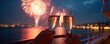 © miss irine - Celebration on yacht with champagne and fireworks. Two glasses of sparkling wine clink against firework display over city at night. Romantic holiday celebration