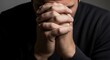 © Nataly - Man praying with hands clasped, deep in thought and seeking solace. Hands clasped symbolize hope and reflection. Praying in moment of reflection and consideration offers inner peace.
