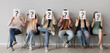© Pixel-Shot - Applicants holding paper sheets with question marks near light wall