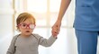 © Margarita Ratatosk - Little baby girl with patching on glasses and nurse holding hand. Pediatric ophthalmology and vision correction for amblyopia in child.