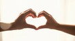 © Valfiyy - Silhouette of Hands Forming Heart Shape Against a Bright Background