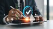 © Graphixa - Business professional using a tablet with a glowing holographic interface displaying a verified checkmark and data analytics symbolizing quality assurance and successful project completion