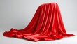 © Innovative - Red satin cloth draped over hidden object on light gray background