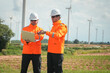 © Surachai - Wind energy workers collaborate on site renewable energy project wind farm outdoor close-up professionalism and safety