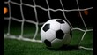 © liliyabatyrova - A soccer ball rolls toward the goal, just inches from the net. The scene is set under a dark sky, creating a thrilling atmosphere for the game
