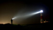 © cheng - keeper. A lighthouse keeper inspecting the beacon at night. mobility guides, transit brochures, designed for mobility and urban transit guides, used by marketing managers.