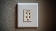 © Honey - Close-up of a recessed electrical outlet on a textured gray wall, perfect for home improvement or electrical safety visuals