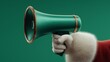 © Natalia S. - Santa’s hand in red sleeve and white fur glove holds shiny green megaphone against matching background. Concept of christmas announcement, sale, and festive holiday communication