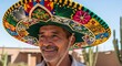 © Mouse - Smiling Mexican Man Wearing a Colorful Sombrero Hat Outdoors.