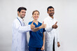 © NVB Stocker - showing thumbs up, Portrait of Professional Healthcare staff Team. Male and female Doctor and nurses medicals staff. Professionalism successful teamwork and Unity