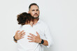 © SHOTPRIME STUDIO - A professional man stands with a colleague in an embrace, showing care and resilience; isolated on a plain white backdrop, this image conveys leadership, emotion, and teamwork.
