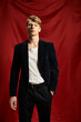 © LIGHTFIELD STUDIOS - Young man exudes modern masculinity with confidence in striking red backdrop