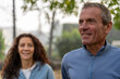 © Marino Bocelli - Mature couple smiling while walking outdoors, enjoying active lifestyle