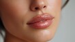 © buraratn - Close-Up Portrait of Beautiful Woman's Lips with Natural Glossy Finish Showcasing Soft Skin and Elegant Makeup Against Neutral Background