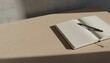 © Super Abi - An open journal with clean blank pages and a pencil resting on a simple wooden desk under the warm glow of natural sunlight, a concept for creativity and new ideas