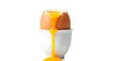 Perfectly softboiled egg in an egg cup, with runny yolk cascading down, showcasing a delicious breakfast treat