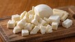© -Quantum Pixels- - Cubed mozzarella cheese arranged on a wooden cutting board, protein-rich meal
